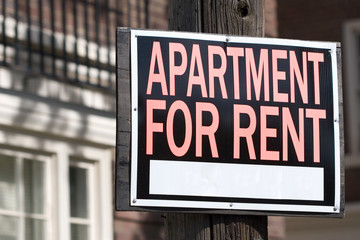 apartment for rent sign in an urban setting