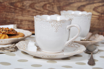 Obraz na płótnie Canvas Tasty fresh buns with granny's tea in a retro cup