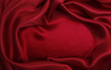 Smooth elegant red silk or satin luxury cloth texture as abstract background. Luxurious background design