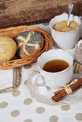 Tasty fresh buns with granny's tea in a retro cup