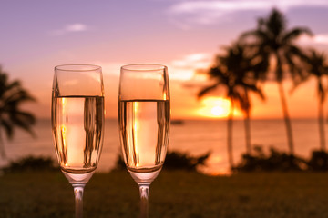 Beautiful sunset, beach and glass of champagne. Romantic destination. 