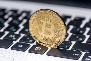 new currency - bitcoin on white laptop keyboard