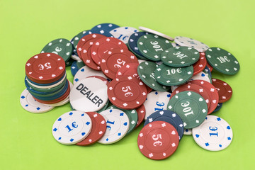 many different poker chips on green background