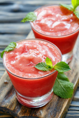 Tasty watermelon smoothie in a glass cup.