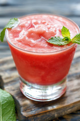 Watermelon smoothie in a glass beaker.