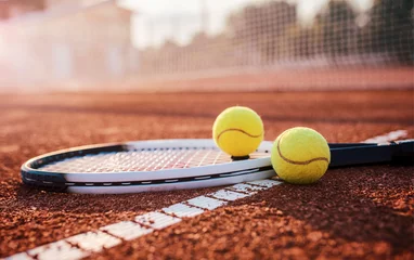 Poster Im Rahmen Tennis ball with racket on the tennis court. Sport, recreation concept © bobex73