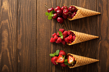 Fresh fruit and berries in waffle cones