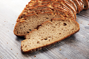 freshly baked bread on wooden board. cutted bread