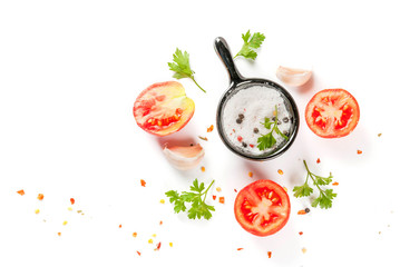 Food preparation background. Isolate. Spices and ingredients for cooking. Fresh tomatoes, whole and sliced, parsley, seasoning, spices, salt, garlic. Top view copy space