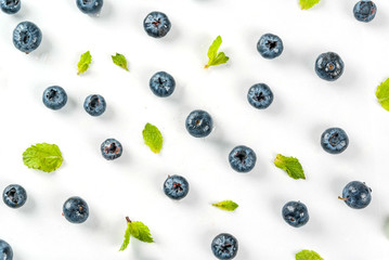 Food preparation background. Isolated, Fresh raw organic blueberry and mint on white background, top view, pattern, copy space