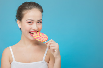 fun girl with candy on blue background