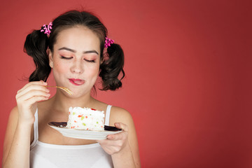 fun pretty girl with sweet dessert on red background