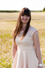 Fototapeta na wymiar Beautiful young woman wearing elegant white dress standing on a white field