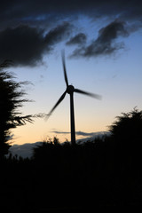A wind turbine in motion against a sunset sky. Taken in West Lothian, Scotland.