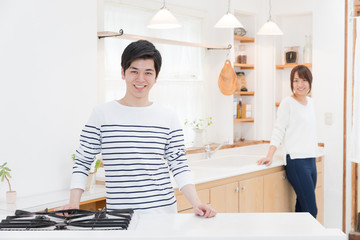 portrait of young asian couple in kitchen