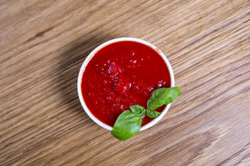 fresh tomato sauce in the white bowl on a wooden background
