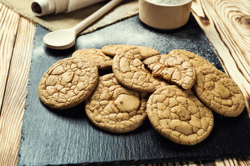 Biscuit sweet cookie background. Domestic stacked butter biscuit pattern concept,close up macro.Homemade cookies on wooden table.Cereal biscuits with the sesame,peanuts,sunflower and amaranth.