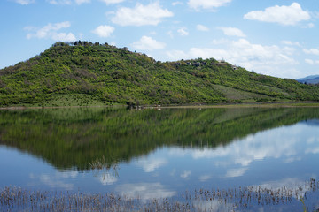 Hill reflecting in the blue lake