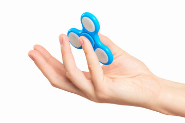 Closeup female hand holding fidget spinner as a popular toy for relaxing.