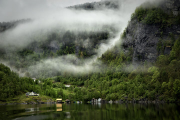 Low cloud clinging to the mountainside in the fjord near Bergen in Norway