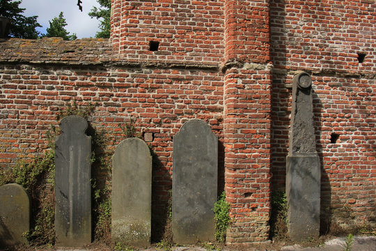 Tombstones near an old wall
