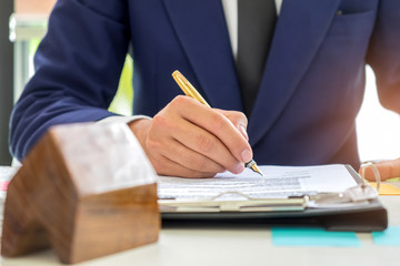 Concept home purchase contract,Businessmen are signing a house purchase contract,The concept of...