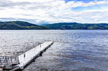 Empty pier dock harbor marina in L'Anse-Saint-Jean, Canada in Quebec village with Saguenay fjord river