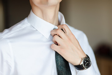 Nervously adjusting his shirt collar . Portrait of anxious businessman loosening his necktie.