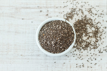 Superfood: chia seeds in a white bowl, top view