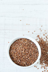 Superfood: flax seeds in a white bowl. Top view