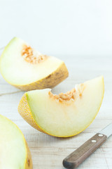 Fresh melons sliced on wooden table