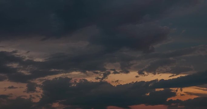 Time lapse clip of evening fluffy curly rolling clouds