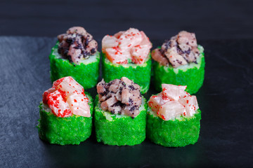 Tasty uramaki sushi roll with scallop, decorated with caviar. Restaurant menu, Japanese food art