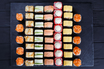 Great assortment of tasty multicolored maki sushi rolls. Japanese food, sushi restaurant serving
