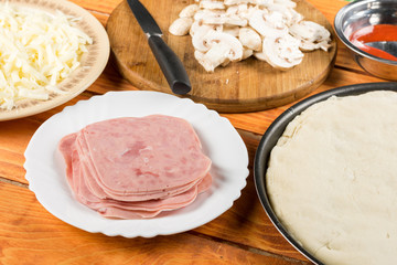 Sliced ham on the table ready for preparing pizza