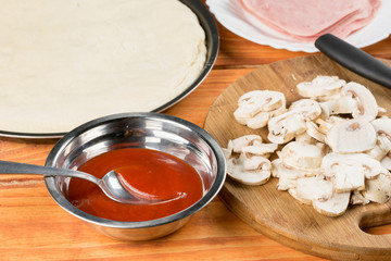 Ketchup in the bowl with mushrooms for pizza