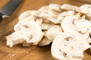 Closeup macro sliced mushrooms on the wooden board