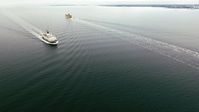 Two ferries sail near the harbor