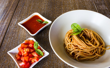  Spaghetti with tomato and basil on wooden background