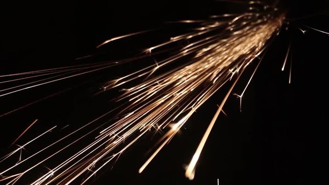 Sparks fly out of the darkness. Screensaver or element for special effects. Black color instead of green background.