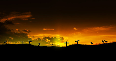 Sun rising on three Christian crosses.