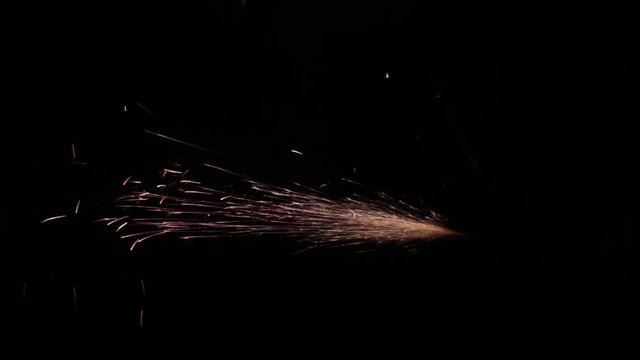 Sparks fly out of the darkness. Screensaver or element for special effects. Black color instead of green background.