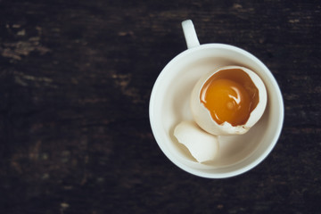 Broken egg in a cup