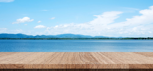 Empty wood table over blue blue sea and sky background, product display montage