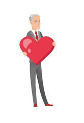 Caucasian businessman holding a big red heart