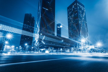Fototapeta na wymiar illuminated modern skyscrapers with traffic trails at night,tianjin city,china.