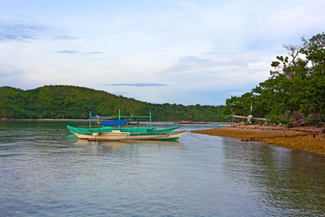 Traditional boats in lagoon of Coron Island, Palawan province, Philippines. Scenic view from the water on Coron Island landscape.