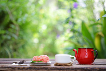 White cup and red tea pot with candy ball
