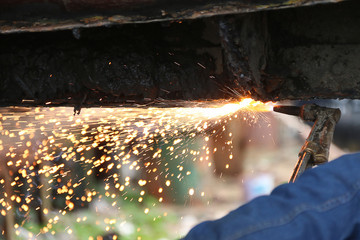 Oxy-Acetylene torch cutting through steel hull