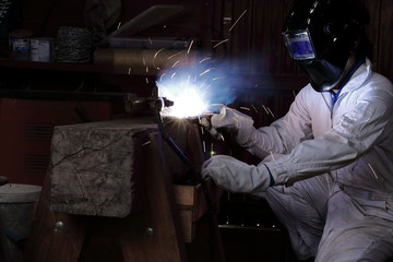 Welder man welding metal in the factory. Industrial concept.